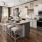 a kitchen with a island and chairs