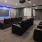 a room with a large screen and chairs